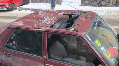 Kars’ta bina çatılarındaki tehlike bir kez daha gündemde... Aracını park eden sürücü hastanelik oldu!