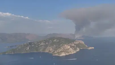Marmaris’te zamana karşı yarış! Sarp kayalıklardaki alevlere zorlu müdahale