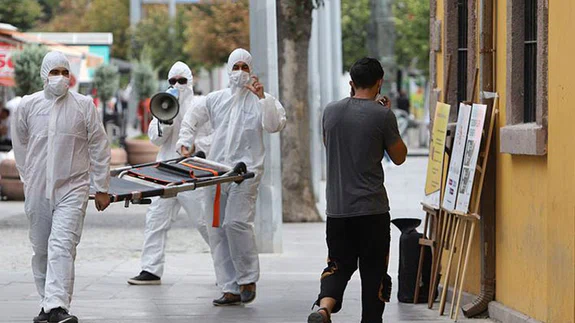 Maske takmayanların önüne sedye ile çıkarak farkındalık oluşturmaya çalıştılar