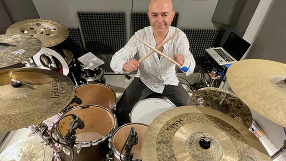 Mehmet Akif öğretmen, ampute koluna sabitlediği bagetle bateri çalıyor